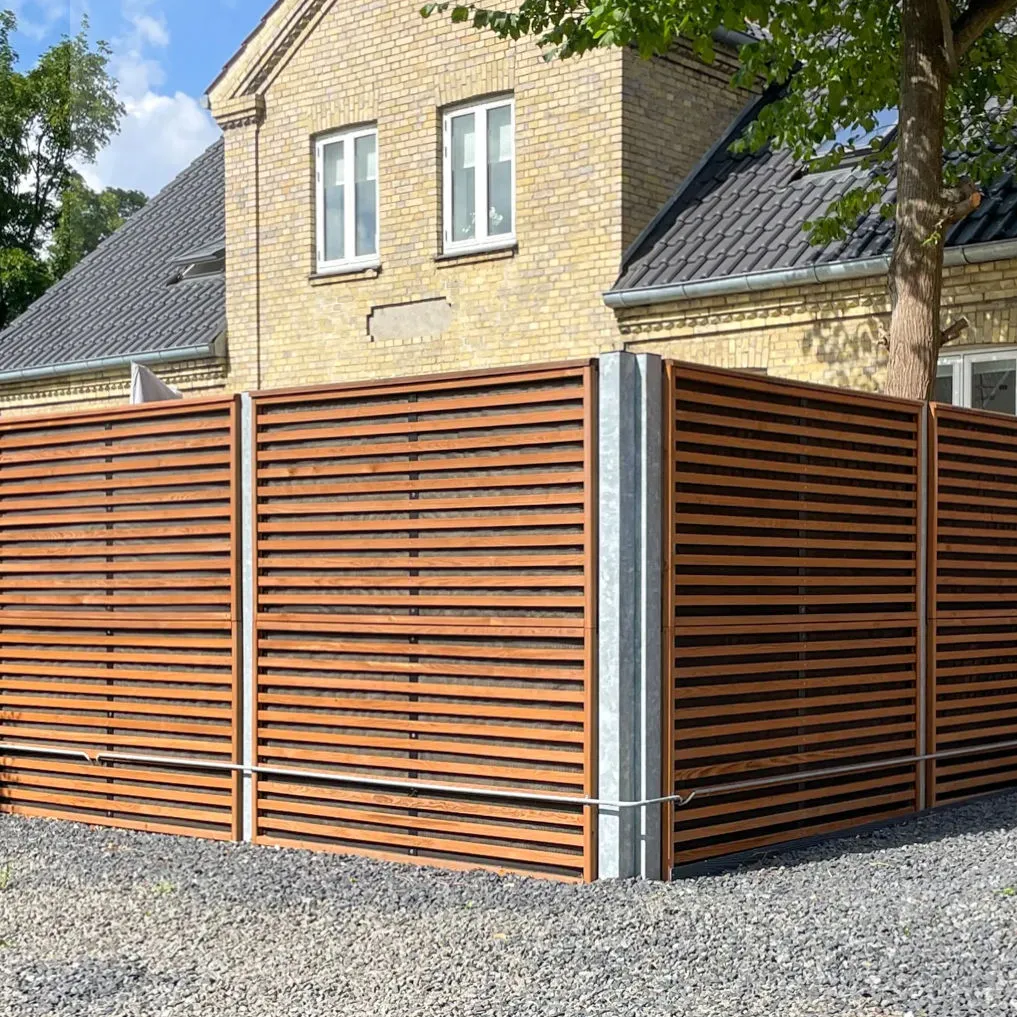 Noistop Wood barrier in a residential garden with natural wood finish and green planting